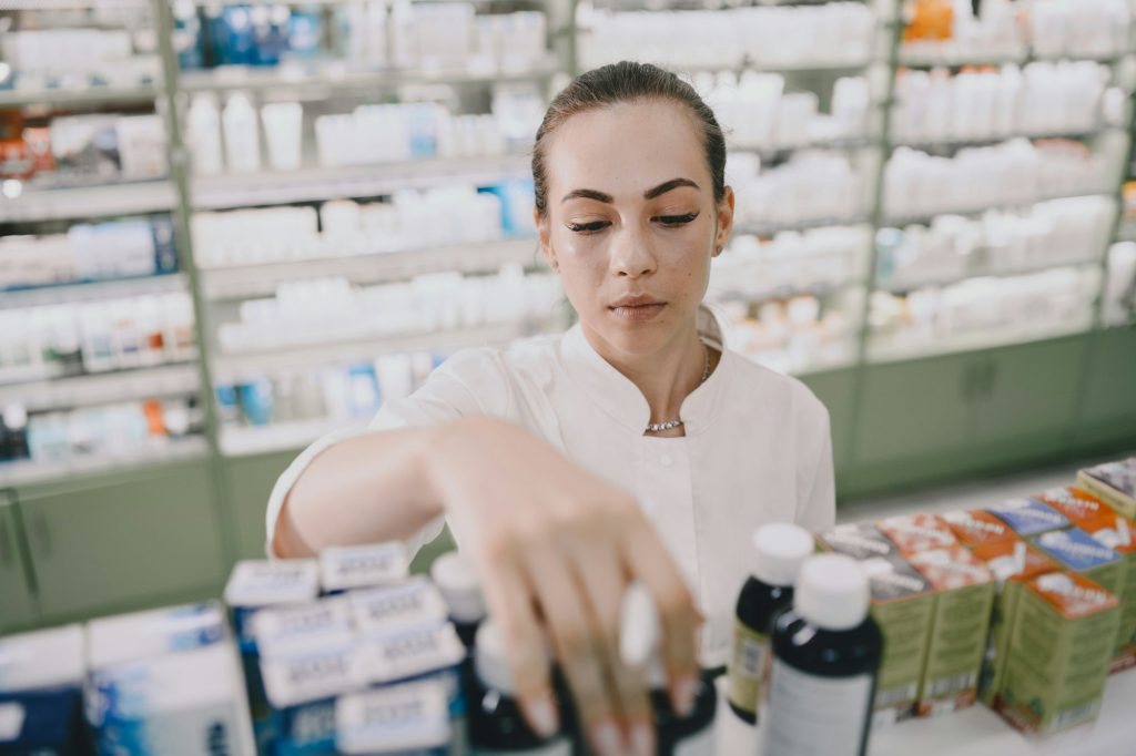 Woman pharmacist checking medicine in pharmacy