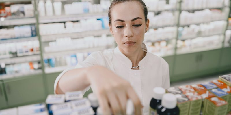 Woman pharmacist checking medicine in pharmacy